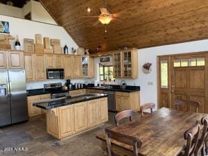 kitchen with wooden ceiling, appliances with stainless steel finishes, glass insert cabinets, dark countertops, and ceiling fan