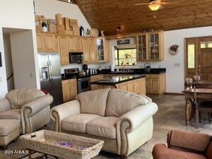 living room with dark wood-style floors, a ceiling fan, vaulted ceiling, and wooden ceiling