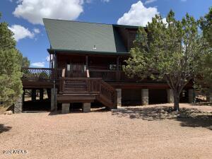 back of property featuring stairs and a wooden deck