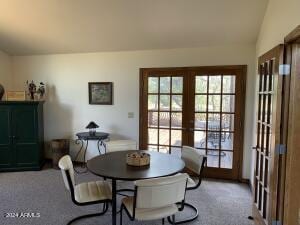 dining room featuring french doors, vaulted ceiling, and carpet