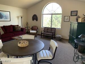 carpeted living room featuring vaulted ceiling