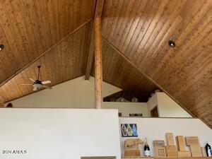 room details featuring wooden ceiling, beam ceiling, and a ceiling fan