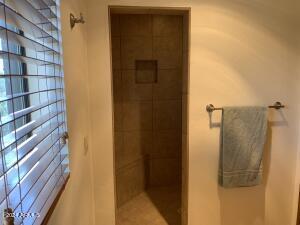 full bathroom with a tile shower