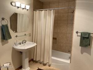 full bath with shower / bath combo and tile patterned floors
