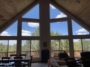 living room with expansive windows, high vaulted ceiling, and wooden ceiling