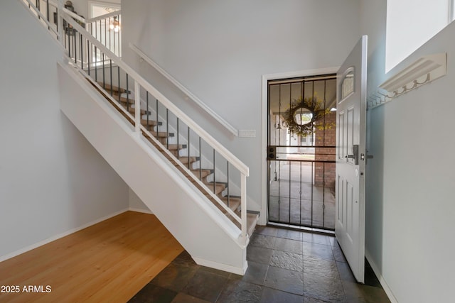 1406 E Jasper Dr, Chandler, AZ 85225 - entryway with a high ceiling, stone tile floors, baseboards, and stairway