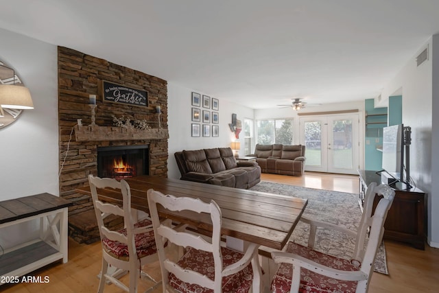 1406 E Jasper Dr, Chandler, AZ 85225 - dining area featuring a fireplace, light wood finished floors, and ceiling fan
