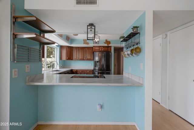 1406 E Jasper Dr, Chandler, AZ 85225 - kitchen featuring stainless steel fridge, light countertops, a peninsula, and a sink