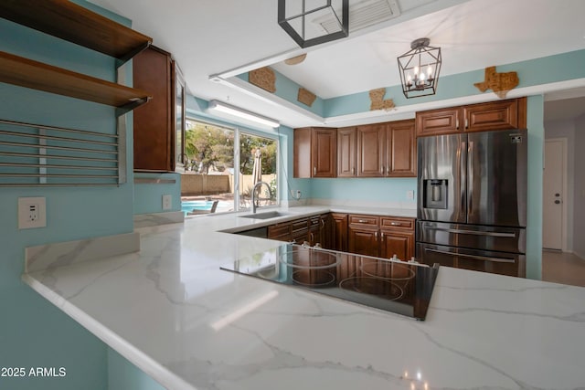 1406 E Jasper Dr, Chandler, AZ 85225 - kitchen featuring stainless steel refrigerator with ice dispenser, a sink, black electric stovetop, and light stone countertops