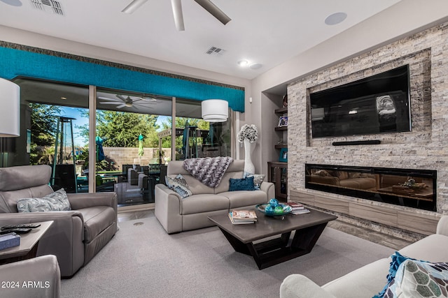 living room featuring a stone fireplace