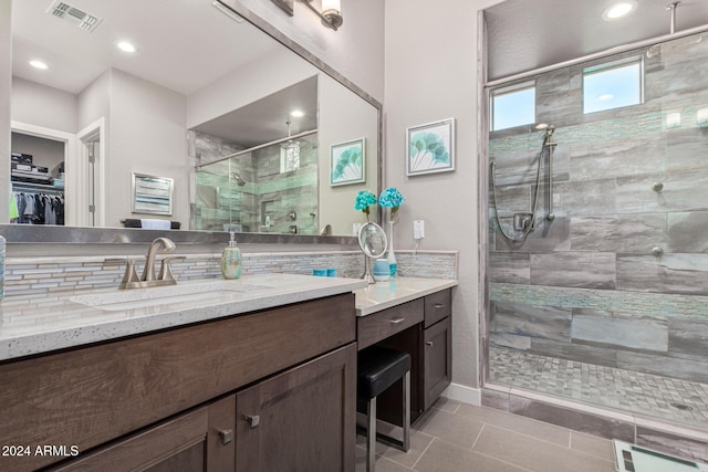 bathroom with tile patterned flooring, vanity, and an enclosed shower