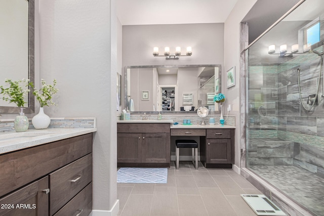 bathroom with tile patterned flooring, vanity, and a shower with shower door