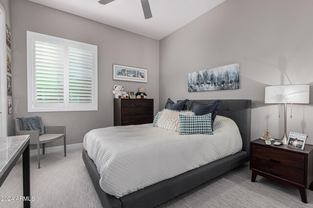 bedroom featuring ceiling fan and light colored carpet