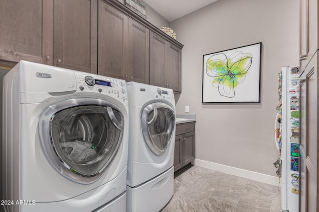 laundry room with cabinets and washing machine and dryer