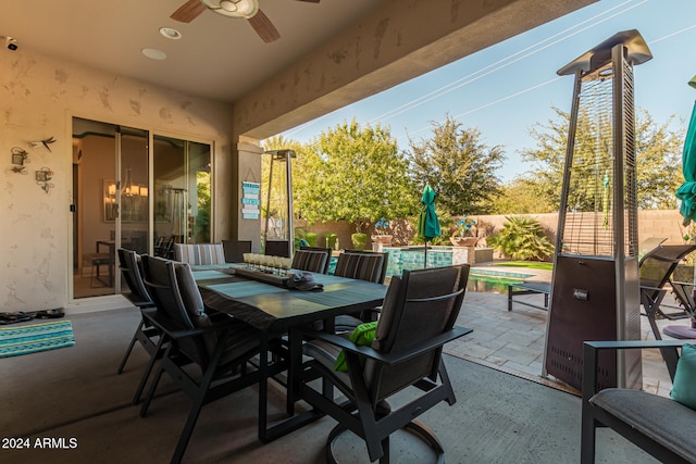 view of patio / terrace featuring a fenced in pool and ceiling fan