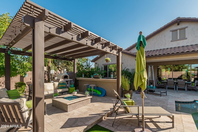 view of patio / terrace featuring a pergola and an outdoor living space with a fireplace