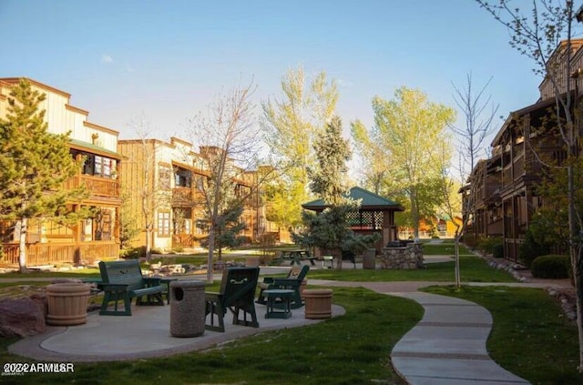 view of community with a yard and a patio