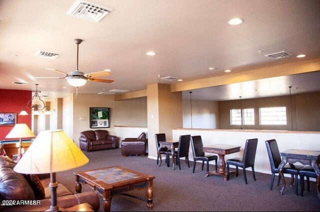 living room featuring ceiling fan and carpet flooring