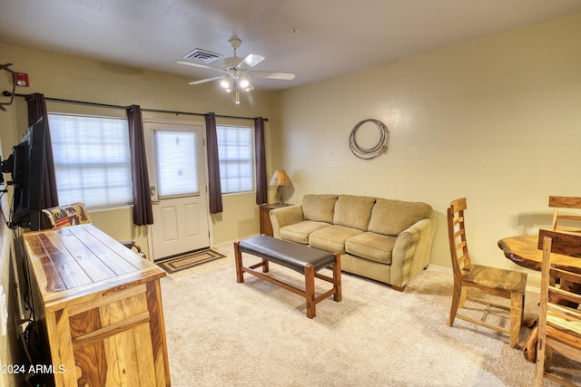 living room featuring carpet floors and ceiling fan