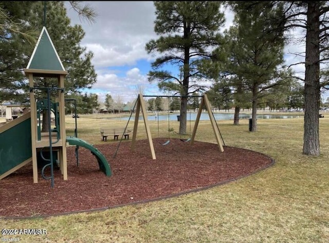 view of play area with a lawn and a water view