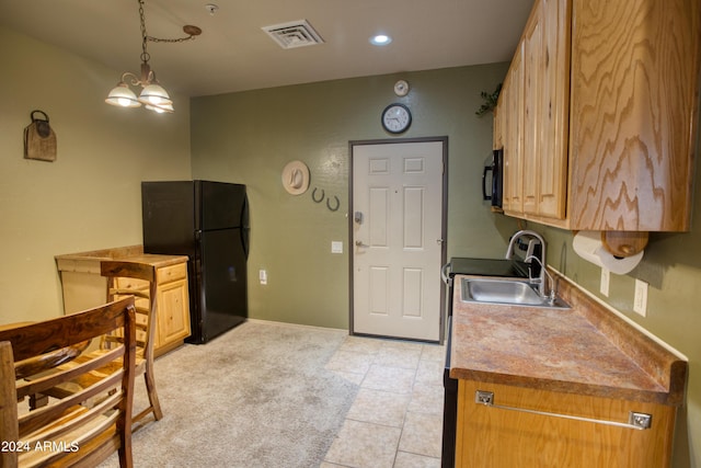 kitchen with pendant lighting, sink, light colored carpet, and black appliances