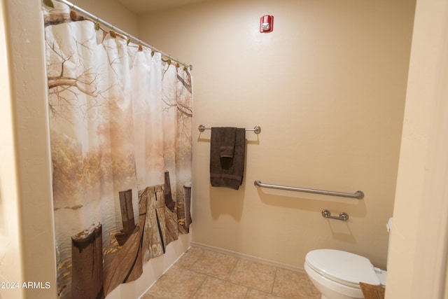 bathroom with tile patterned floors, toilet, and a shower with shower curtain