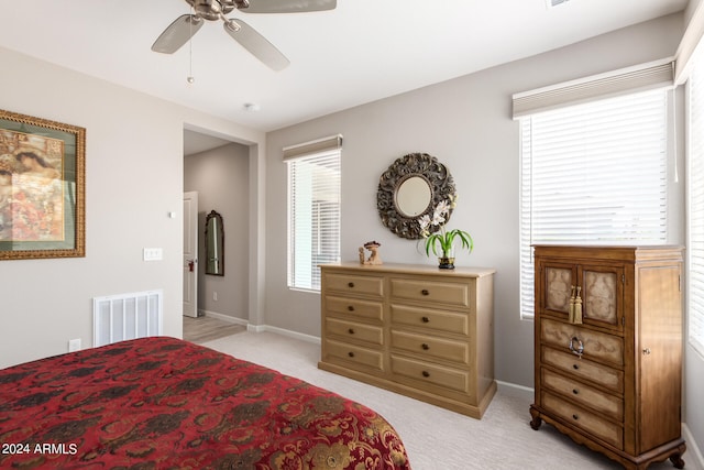 bedroom featuring ceiling fan and light colored carpet