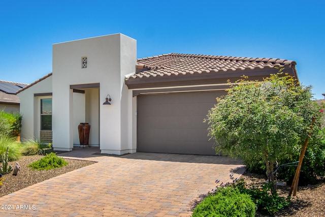 view of front of home featuring a garage and solar panels