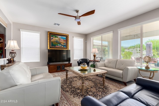 living room featuring hardwood / wood-style floors and ceiling fan