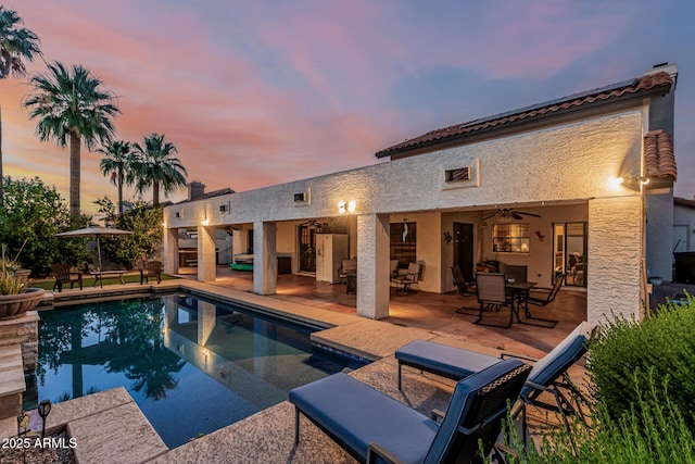 6133 E Saddleback St, Mesa, AZ 85215 - pool at dusk featuring a ceiling fan, a patio, and an outdoor pool
