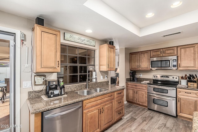 6133 E Saddleback St, Mesa, AZ 85215 - kitchen featuring appliances with stainless steel finishes, a sink, recessed lighting, light wood-style floors, and stone counters