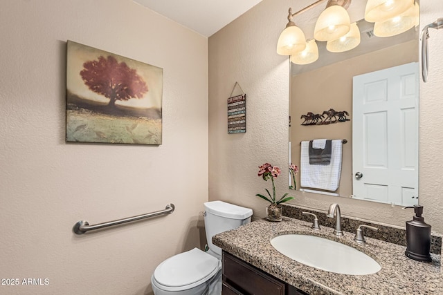6133 E Saddleback St, Mesa, AZ 85215 - bathroom featuring toilet, vanity, and a textured wall