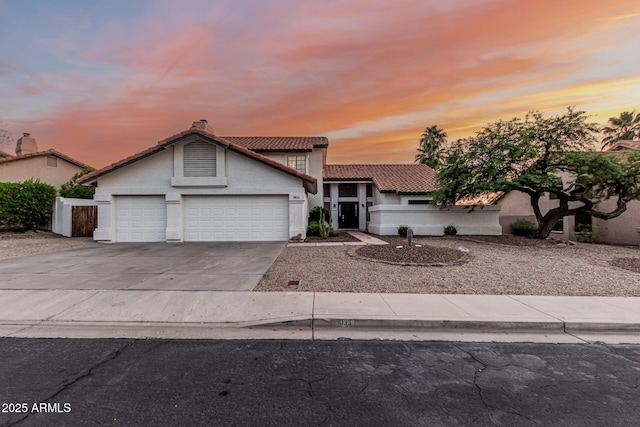 6133 E Saddleback St, Mesa, AZ 85215 - view of front of house with a tile roof, an attached garage, stucco siding, and concrete driveway