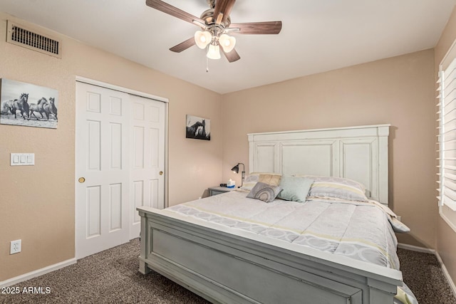 6133 E Saddleback St, Mesa, AZ 85215 - bedroom with dark carpet, baseboards, a ceiling fan, and a closet