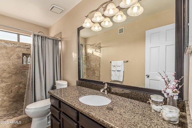 6133 E Saddleback St, Mesa, AZ 85215 - bathroom with toilet, tiled shower, and vanity