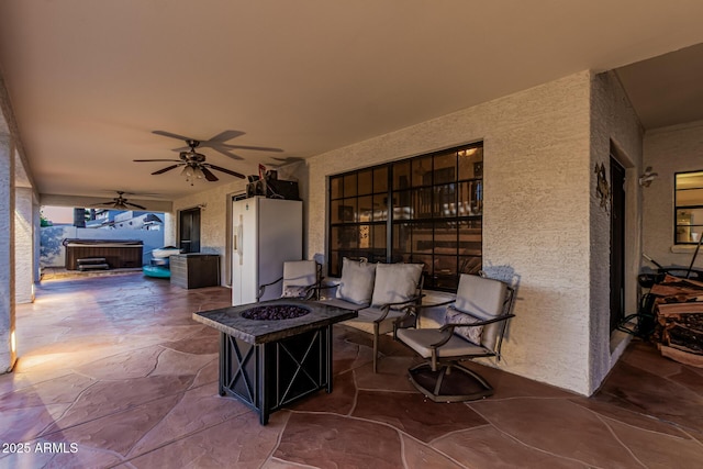 6133 E Saddleback St, Mesa, AZ 85215 - view of patio / terrace with a hot tub, a ceiling fan, and an outdoor living space with a fire pit