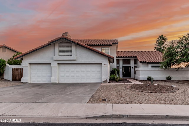 6133 E Saddleback St, Mesa, AZ 85215 - view of front facade with a tiled roof, concrete driveway, stucco siding, and a garage