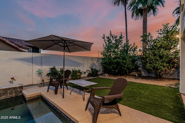6133 E Saddleback St, Mesa, AZ 85215 - patio terrace at dusk featuring a patio area