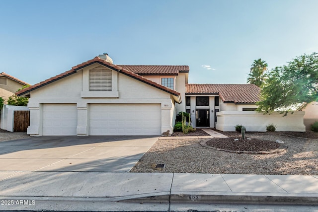 6133 E Saddleback St, Mesa, AZ 85215 - mediterranean / spanish-style home featuring a tiled roof, driveway, stucco siding, and an attached garage