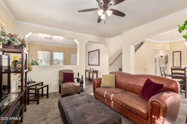 living room featuring carpet, ceiling fan, and crown molding