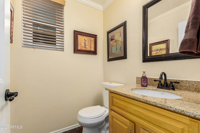 bathroom with vanity, toilet, and ornamental molding