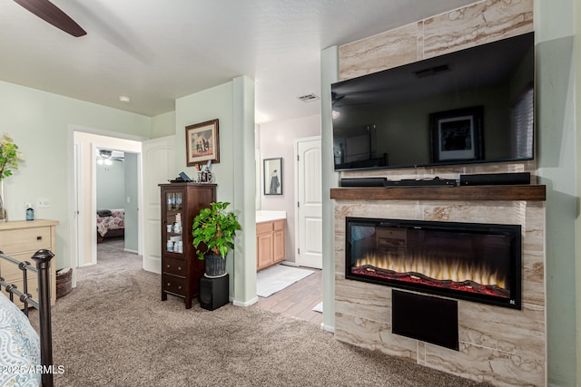 carpeted living room with a high end fireplace