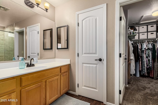 bathroom featuring vanity and an enclosed shower