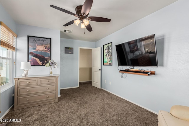 bedroom featuring ceiling fan and dark carpet