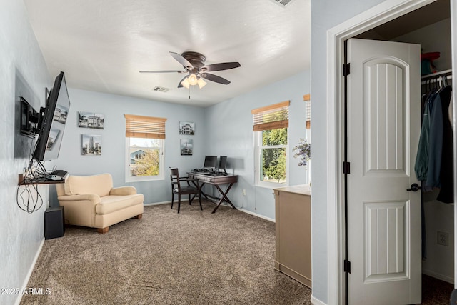 home office featuring carpet, a wealth of natural light, and ceiling fan