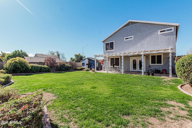 rear view of property featuring a lawn, a pergola, french doors, and a patio