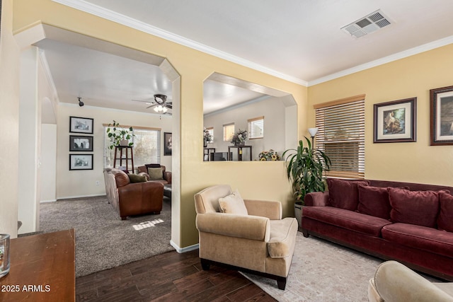 living room featuring ceiling fan and ornamental molding