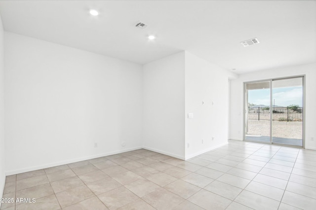 empty room with light tile patterned floors, baseboards, recessed lighting, and visible vents