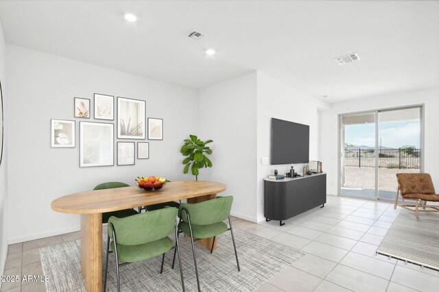 dining space featuring light tile patterned flooring, baseboards, and visible vents