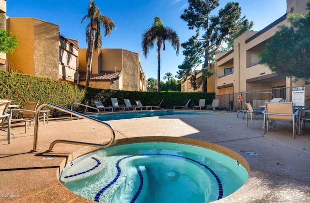 view of pool featuring a patio and a hot tub